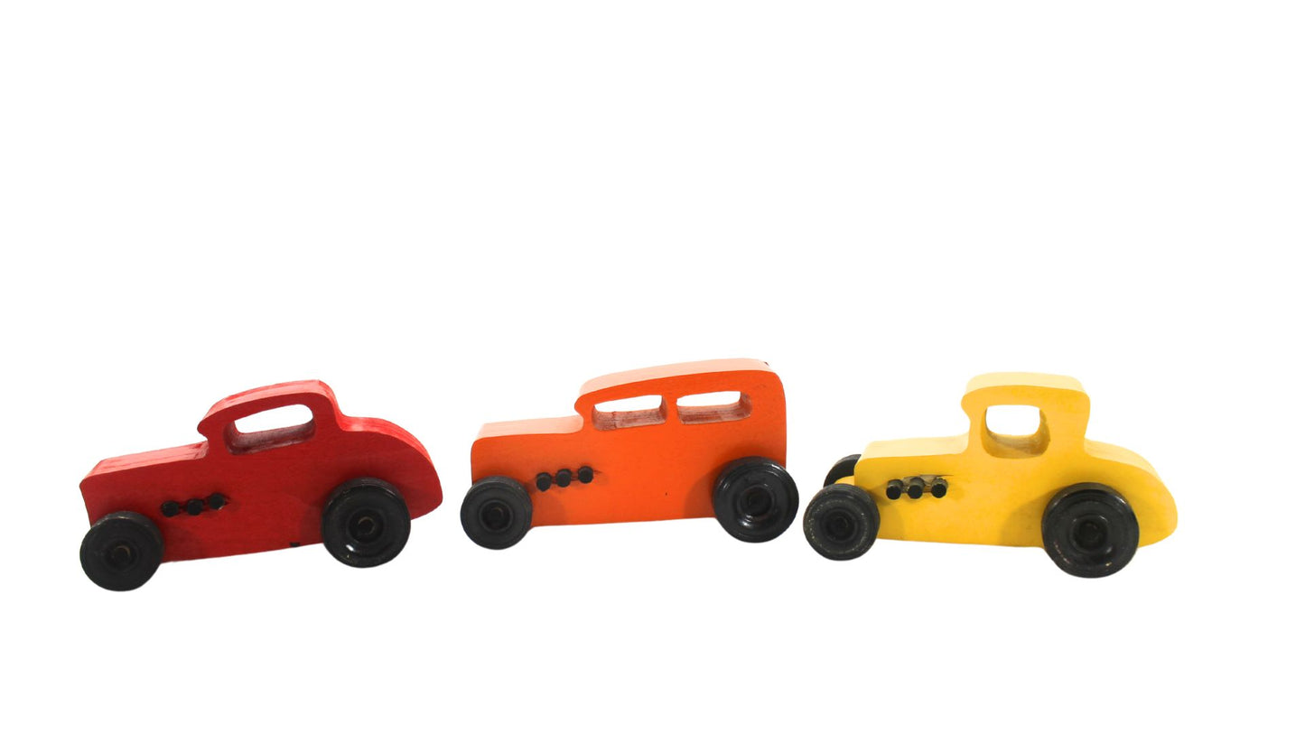 Wooden toy Ford hot rod set, 3 cars, painted yellow, red, and orange