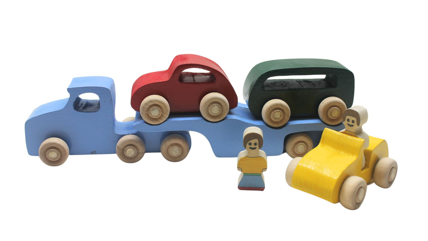 Volkswagen car carrier solid wood toy. Set includes a tractor with separate trailer, a VW bug, convertible, and van, and two people