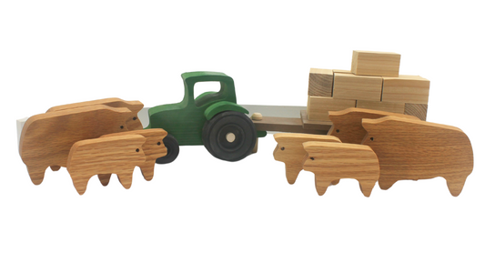 Cattle ranch play set. Includes a tractor pulling a wagon, hay bales, fence sections, cows and calves