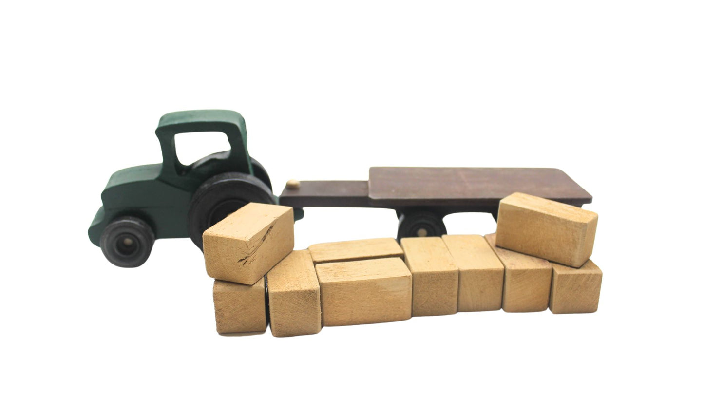 Cattle ranch play set. Includes a tractor pulling a wagon, hay bales, fence sections, cows and calves