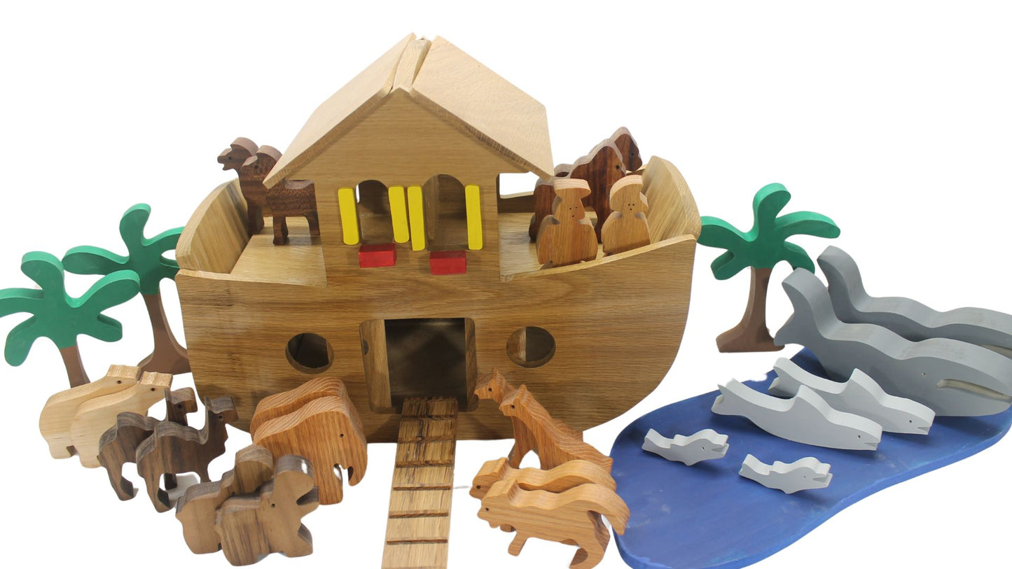 Handcrafted wood Noah's ark with 11 pairs of animals. A ramp leads to the sliding doors in the ark's side for the animals to enter.