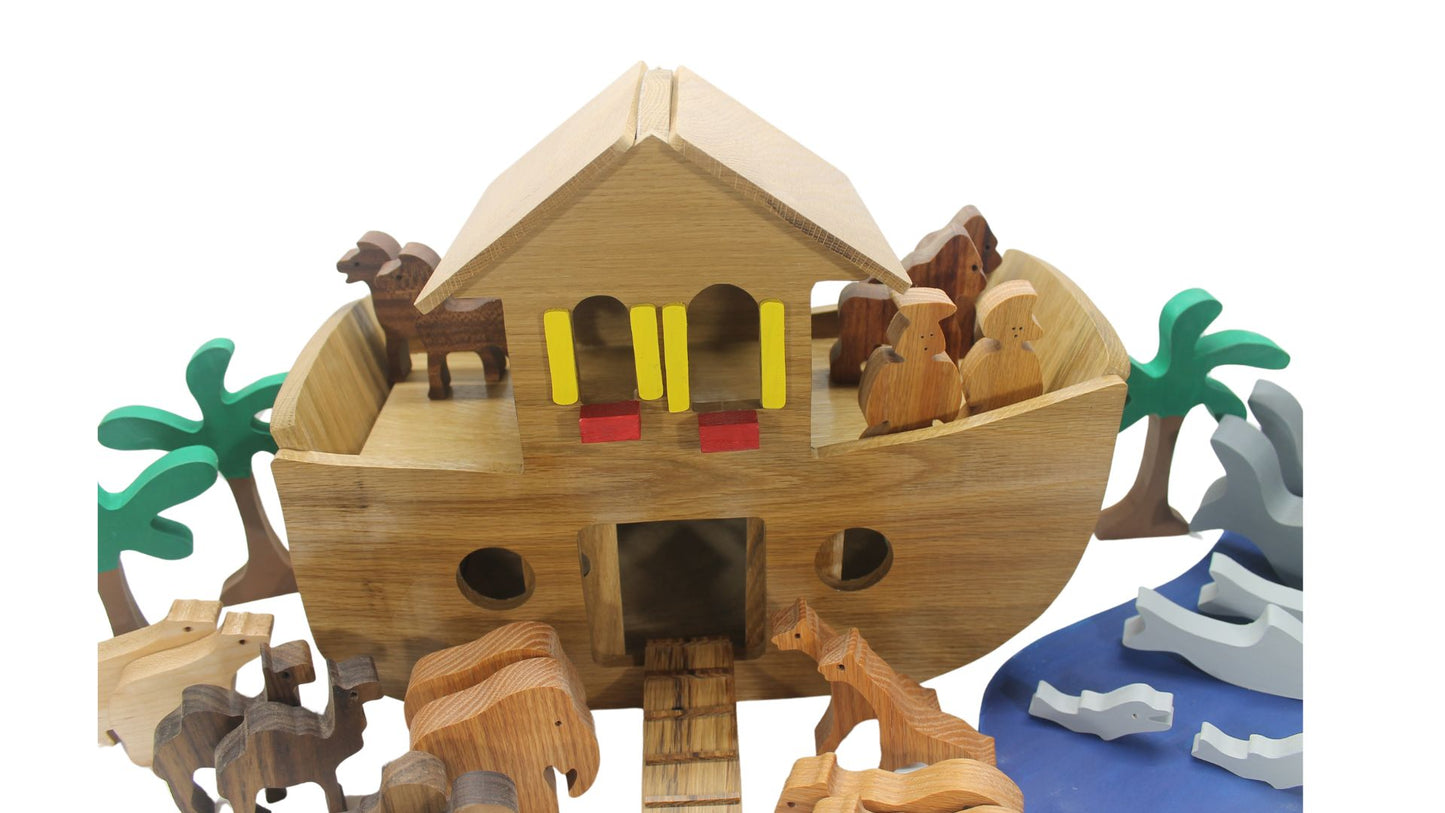 Handcrafted wood Noah's ark with 11 pairs of animals. A ramp leads to the sliding doors in the ark's side for the animals to enter.